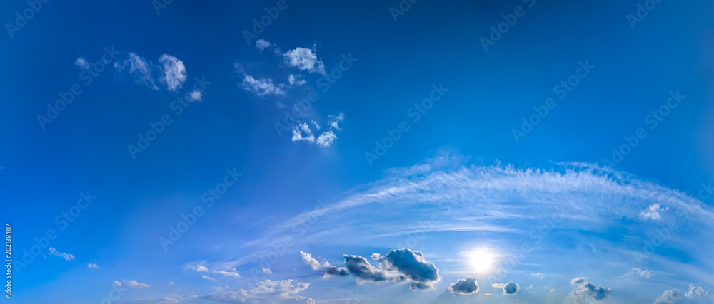 Obraz premium Rows soft steam stretch forming a striking natural pattern. Cloud layers moving dynamically right to left. Cumulus clouds clusters warm summer day vast blue sky. Large copy space above for writing.