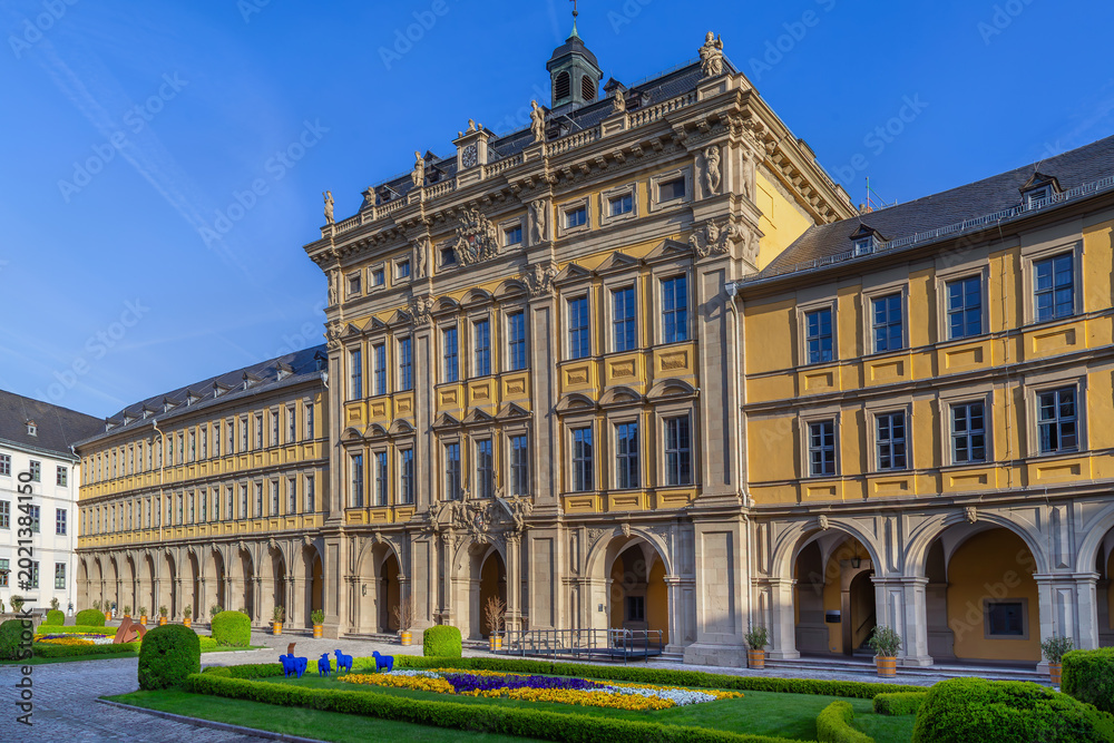 Obraz premium Front view of Stiftung Juliusspital hospital in Wurzburg Germany. Historic Baroque palace facade under clear blue sky