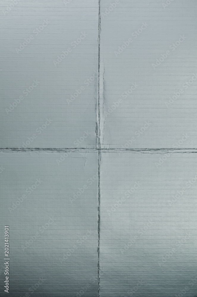 Fototapeta premium Paper Overlay, Close-up of highly reflective silver foil paper with visible fold lines and metallic texture.