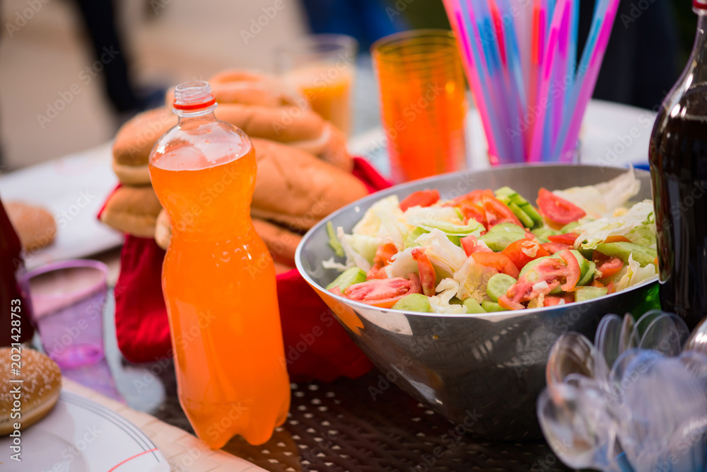 Fototapeta premium Middle Eastern modern family enjoying Eid Ramadan iftar dinner with salad, bread and drinks at home