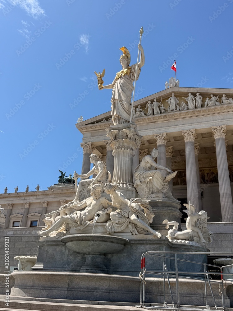 Obraz premium Austrian Parliament building and Pallas Athena fountain in Vienna Austria