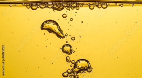 Golden Bubbles Rising in Liquid Closeup.