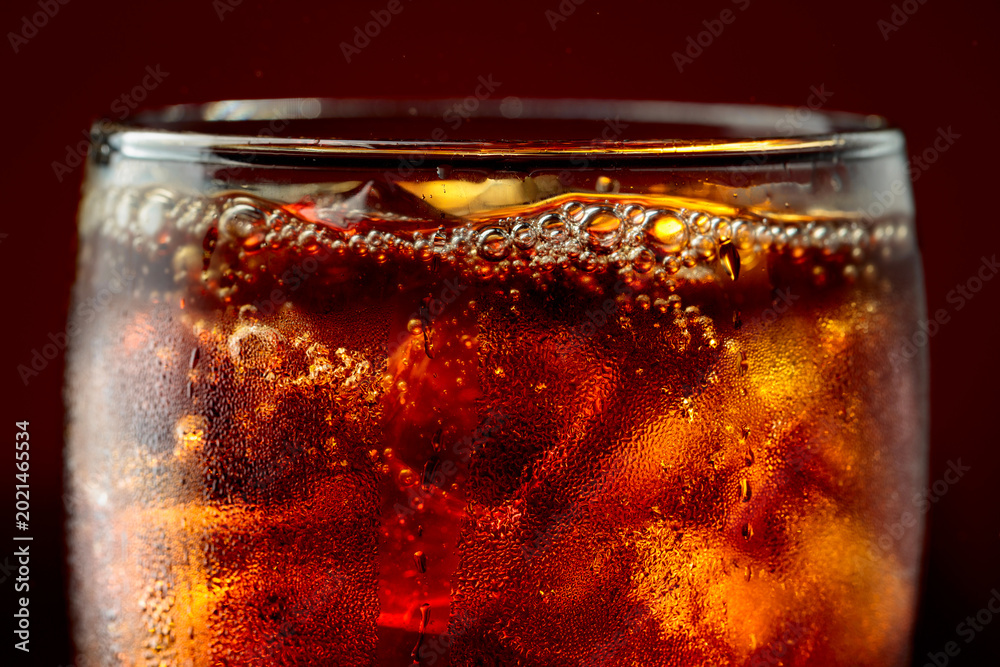Fototapeta premium Fizz sparkling cola bubbly soda pop with ice cubes.