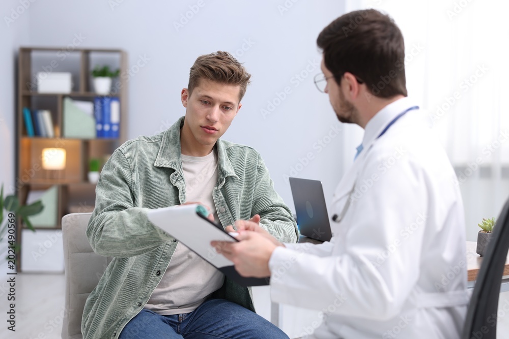 Fototapeta premium Man having appointment with doctor in clinic, selective focus