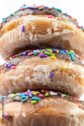 Billede på lærred Stack of glazed donuts with rainbow sprinkles