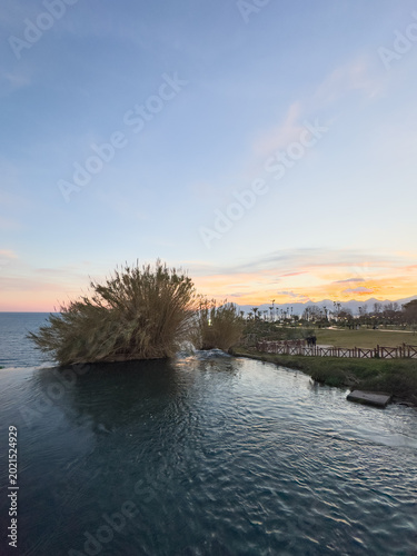 Quadro em tela Düden Waterfall pours dramatically into the turquoise Mediterranean Sea beside Antalya’s coastal cliffs under textured clouds and vibrant natural scenery