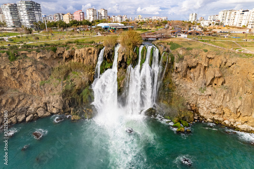 Картината върху платно Düden Waterfall pours dramatically into the turquoise Mediterranean Sea beside Antalya’s coastal cliffs under textured clouds and vibrant natural scenery