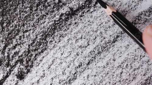 close up of charcoal pencil drawing on textured paper. slow motion footage. Background video can be used as overlay. doodling hatching