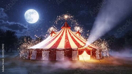a red and white striped circus tent at night.
