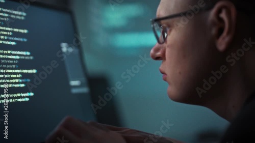 Coding diligently, a bespectacled programmer works at a desktop PC, harnessing artificial intelligence to generate code faster. The workstation buzzes with efficiency, highlighting development tools