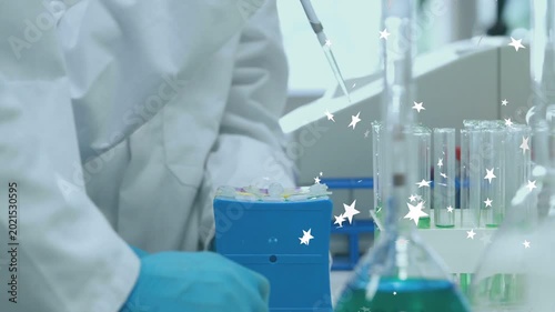 Female lab tech using pipet aspirating or dispensing for testing in lab with animated stars over tub