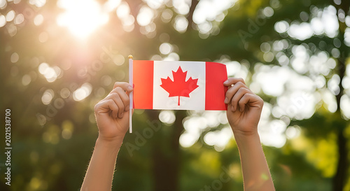Person holding canadian flag in a blooming garden