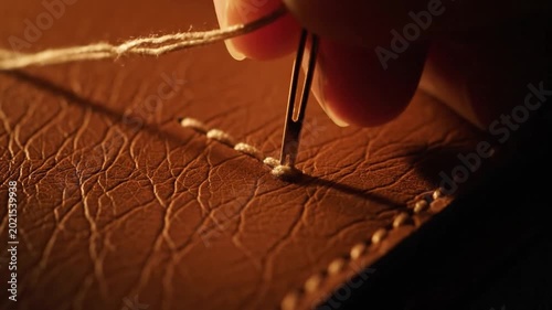 Extreme close-up of stitching on sustainable mushroom leather texture.