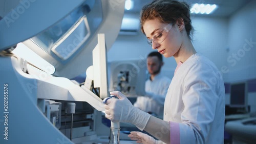 Laboratory technicians examining biological samples using modern diagnostic equipment. Concept virology research, epidemic prevention and medical innovation, hantavirus and coronavirus testing include
