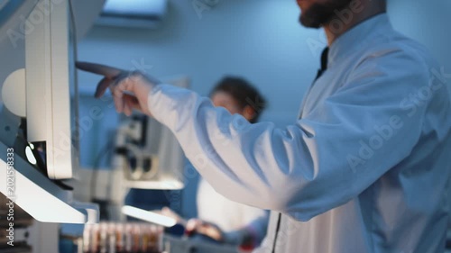 Scientists in modern laboratory conducting infectious disease analysis. Concept virology, epidemic research and global health protection focused on coronavirus and hantavirus.

