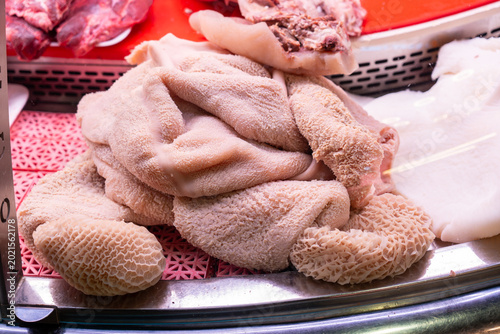 Fotografie Detailed view of cleaned, raw honeycomb tripe arranged on a tray at a local meat market or slaughterhouse