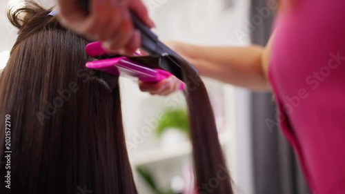 Hairdresser doing hairstyling in a beauty salon. Beautiful female hair after procedures in a hairdressing salon. High quality 4k footage