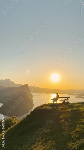 Person Sitting Alone on Bench Watching Sunset Over Lake Lucerne at Märibänkli Viewpoint Above Vitznau, Rigi, Switzerland