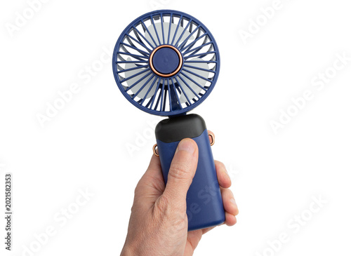 Quadro em tela Handheld portable fan held by a hand isolated on a white background