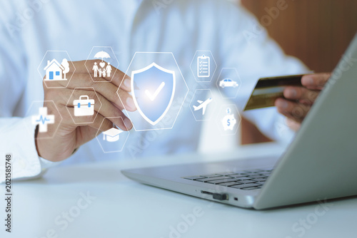 Person holding credit card with insurance icons for health, life, and property. Concept of financial protection, employee benefits, healthcare coverage, and diverse insurance policies