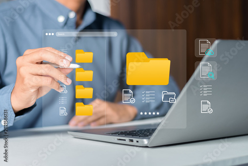 Quadro su tela Businessman organizing digital folders and files on a virtual computer interface