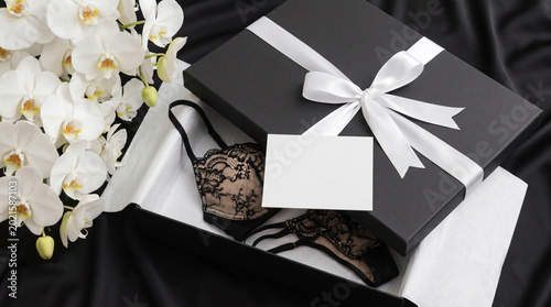 Premium lingerie brand packaging mockup with blank card and white orchid decor