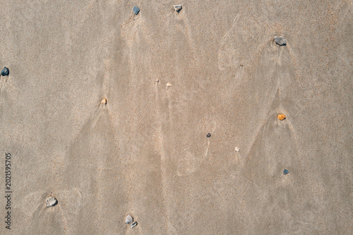 Beach Sand with Scattered Pebbles and Wind Patterns