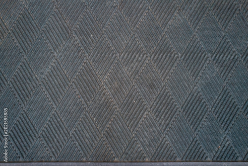 Dark Rubber Mat Texture with Repeating Geometric Pattern