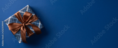 Bild auf Leinwand Blue plaid gift box with brown satin ribbon for Father's Day banner celebration