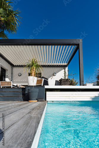 Modern single storey house with bioclimatic pergola and pool