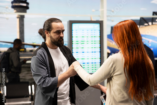 Konstfotografi Sweet couple in love sharing intimate moment in airport lounge, caressing and holding hands