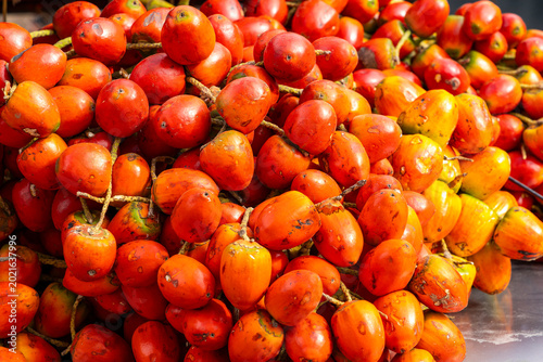 A vibrant display of chontaduros palm fruit in a traditional Colombian market - Bactris gasipaes