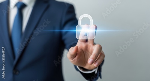 Businessman's finger activating a glowing digital lock icon, representing cybersecurity and data protection strategies in business.