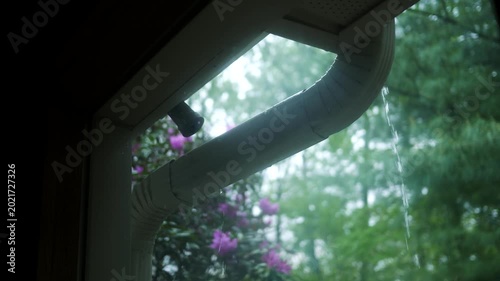  Looking out Window at Leaky Gutter System - Filler Shot - Drainage Flooding Concept