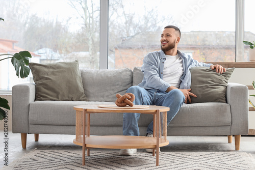 Young man sitting on sofa n...