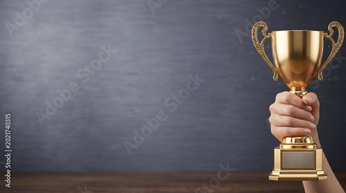 Woman hand holding gold trophy cup for victory and success