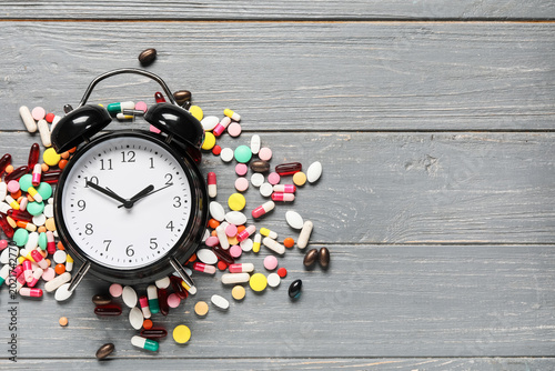 Alarm clock with pills on g...