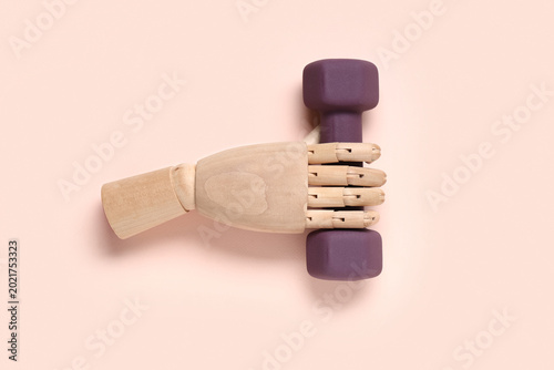 Wooden hand with dumbbell o...