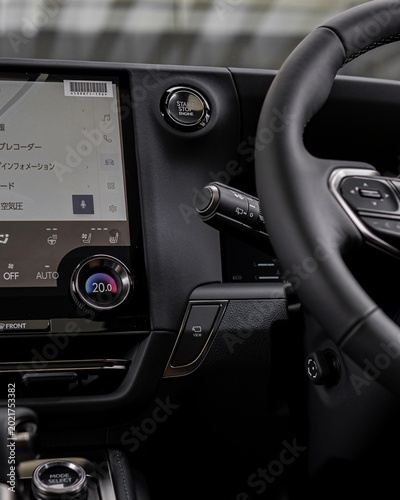 Modern car dashboard and steering wheel interior view.