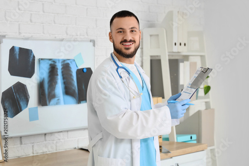 Male doctor working with cl...