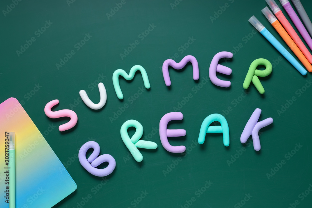 Fototapeta premium Composition with text SUMMER BREAK made of play dough, markers and notebook on green background