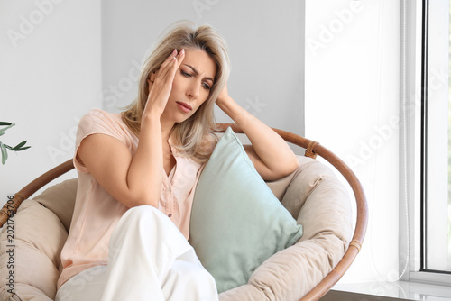 Mature woman with headache ...