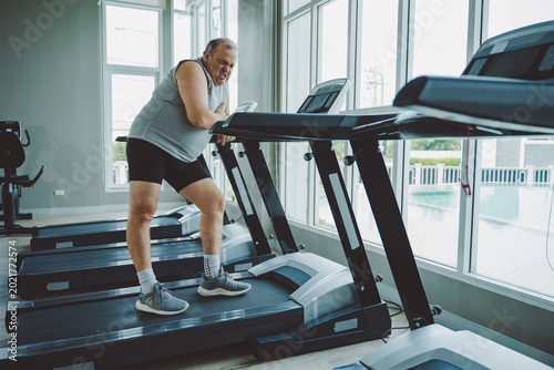 Bild auf Leinwand Senior Man Suffering Chest Pain from Possible Heart Condition in Gym