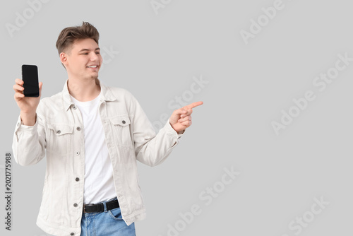 Young man with mobile phone...
