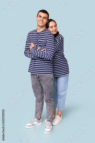 Cheerful young couple huggi...