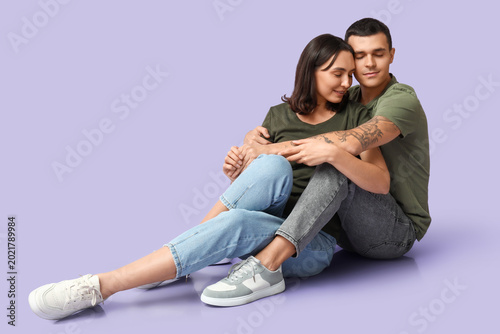 Happy young couple sitting ...