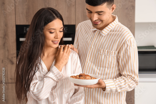 Happy young couple having b...