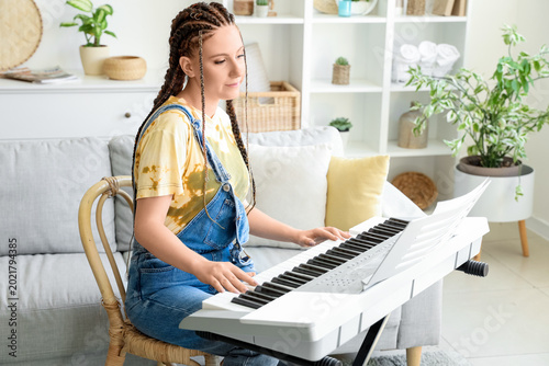 Young woman with dreadlocks...
