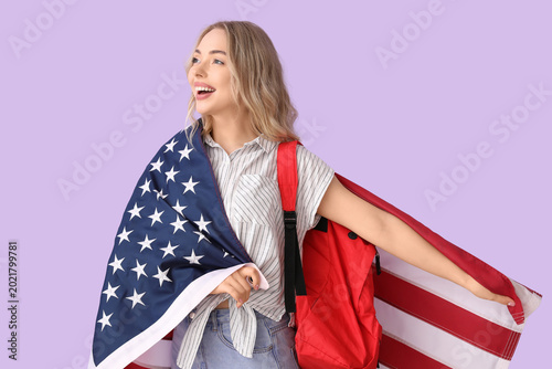 Female student with USA flag on lilac background