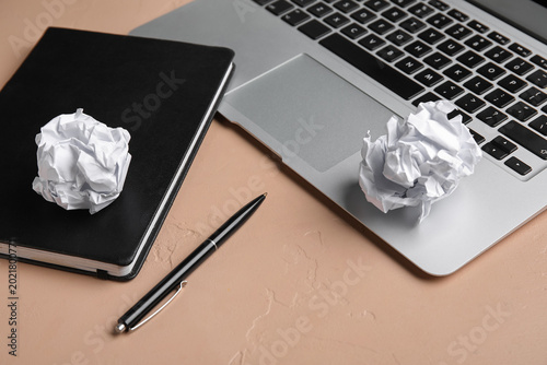 Notebook, pen, crumpled pap...